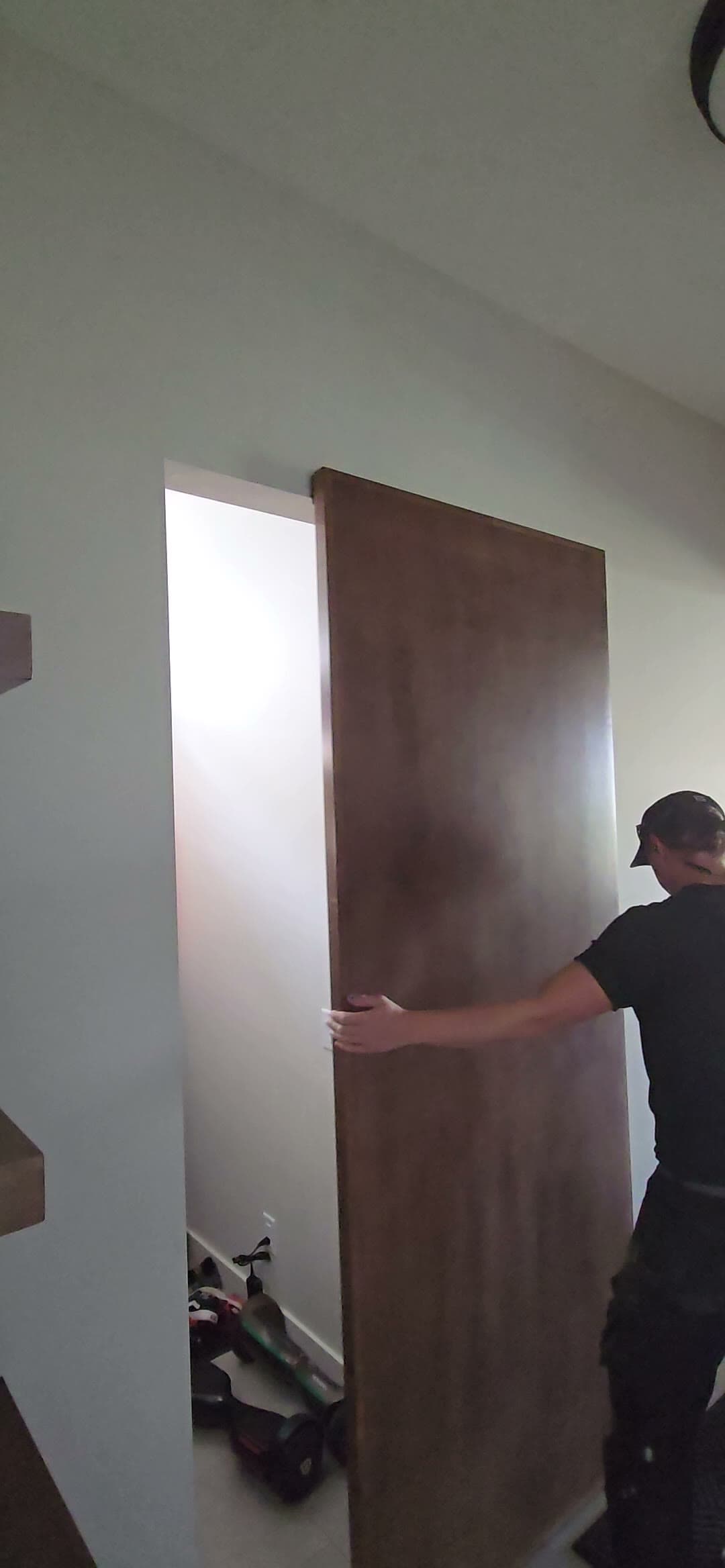Michael hanging a large flush walnut-veneer door on site