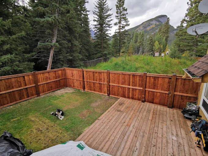 New cedar privacy fence and deck build with a mountain backdrop