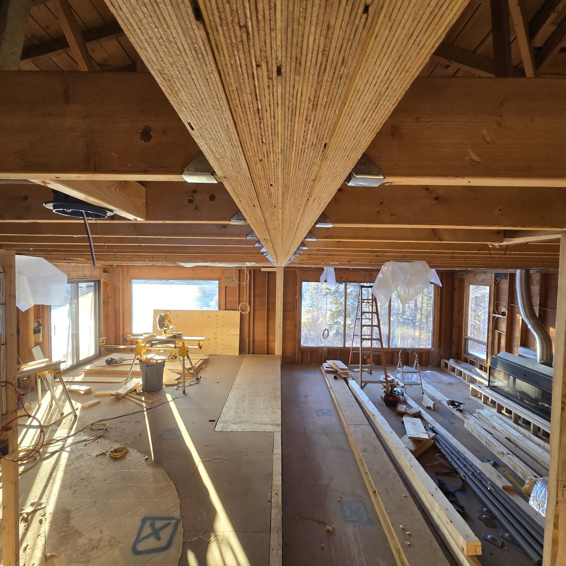 Vaulted great room under construction with exposed post-and-beam timber framing