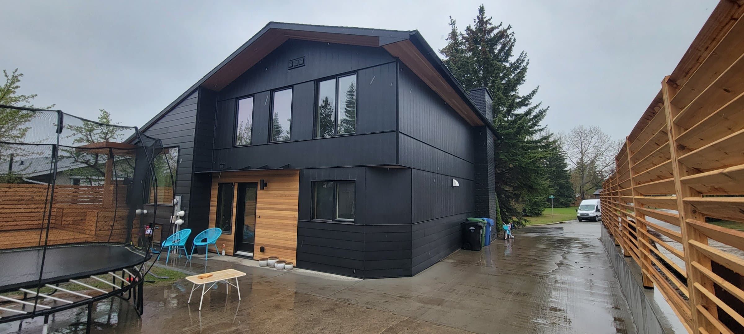 Modern black board siding with cedar accent trim on a full exterior re-clad